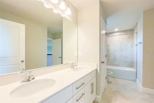 a bathroom with a toilet sink and a mirror