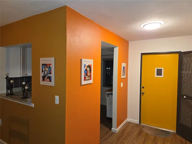an empty room with wooden floor and closet