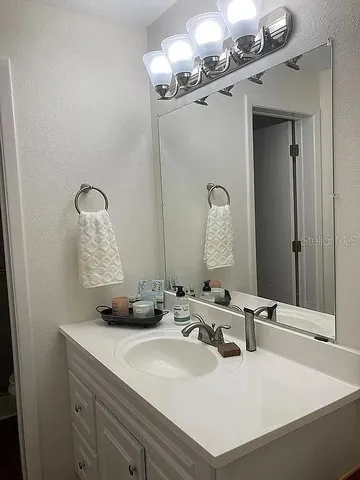 a bathroom with a sink and a mirror