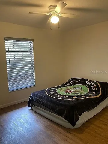 a bed sitting in a bedroom next to a window