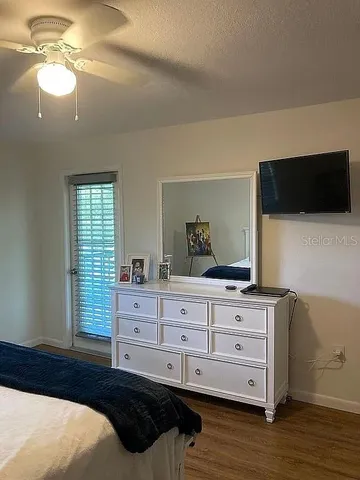 a bedroom with a bed and a flat screen tv