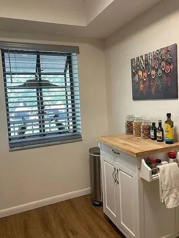 a view of a kitchen cabinets a sink and wooden floor
