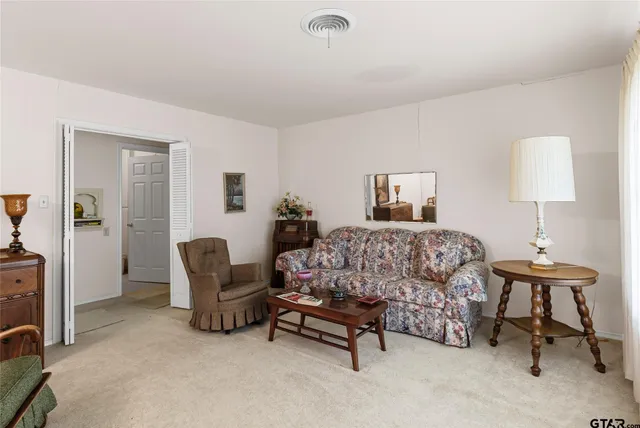 a kitchen with white cabinets white appliances and sink