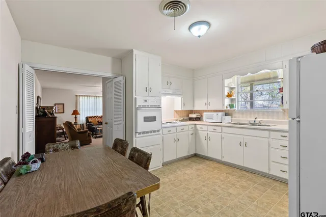 a spacious bedroom with a bed and cabinets