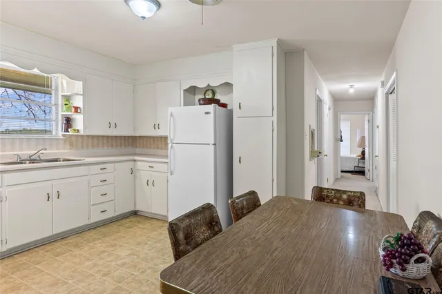 a dining room with furniture and chandelier