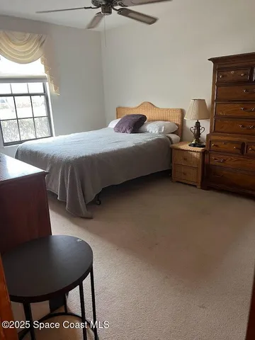 a bedroom with a bed a dresser and a window