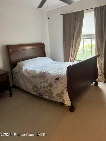 a bedroom with a bed chair and a window