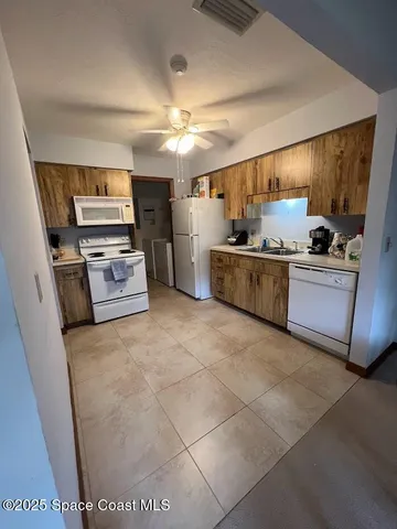 a large kitchen with cabinets and stainless steel appliances