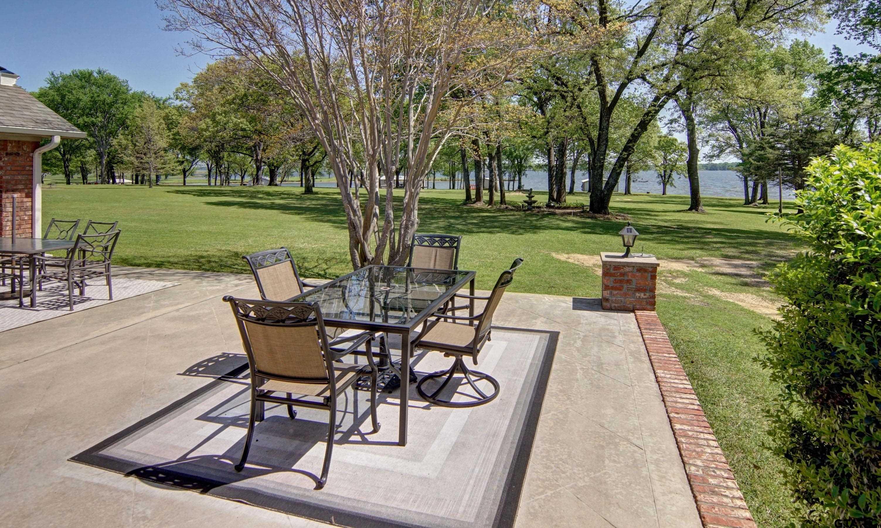 227 Private Road 5885 Yantis, TX 75497 - Photo 16 of 41 a view of a backyard with sitting area