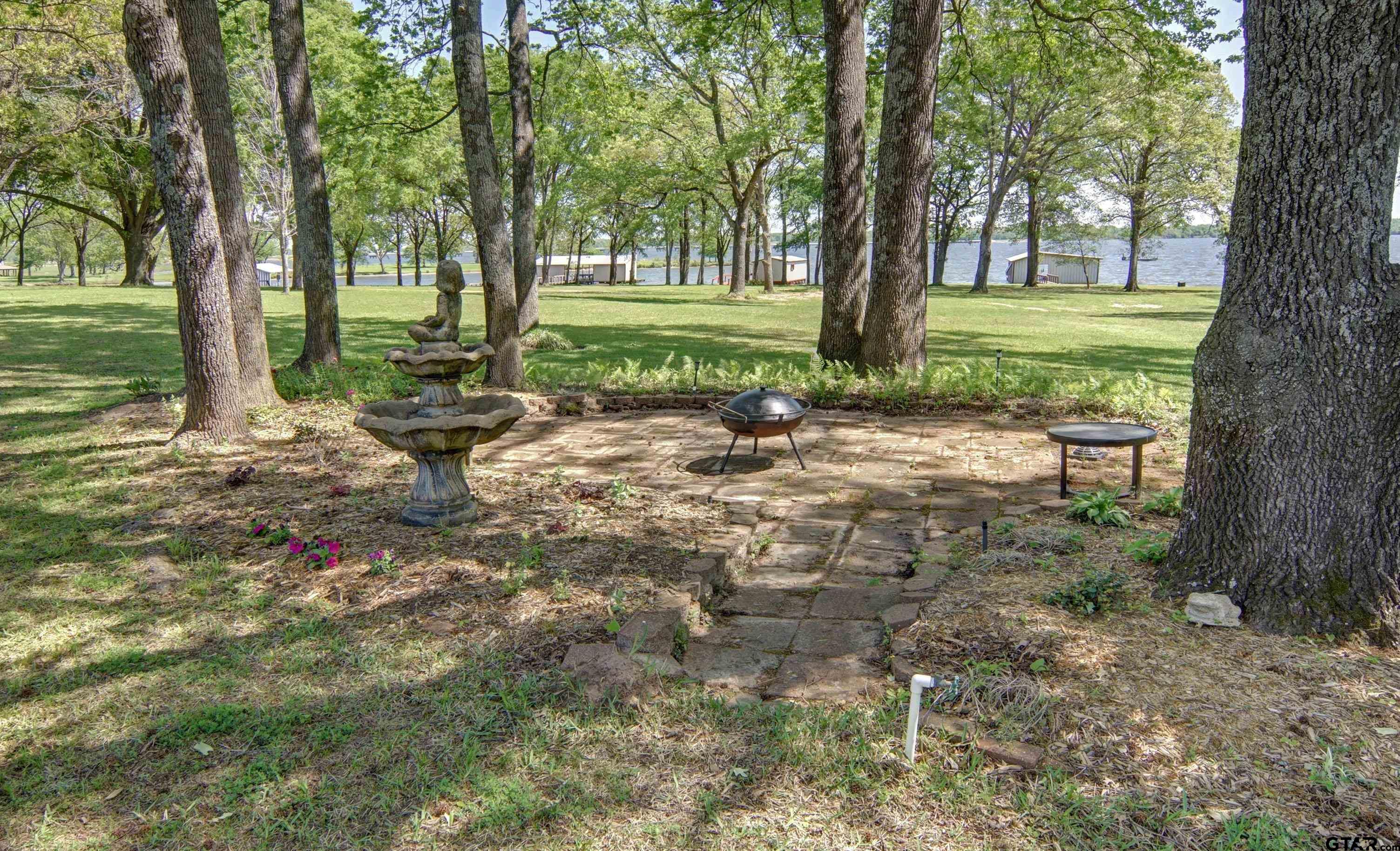 227 Private Road 5885 Yantis, TX 75497 - Photo 17 of 41 a backyard of a house with lots of green space