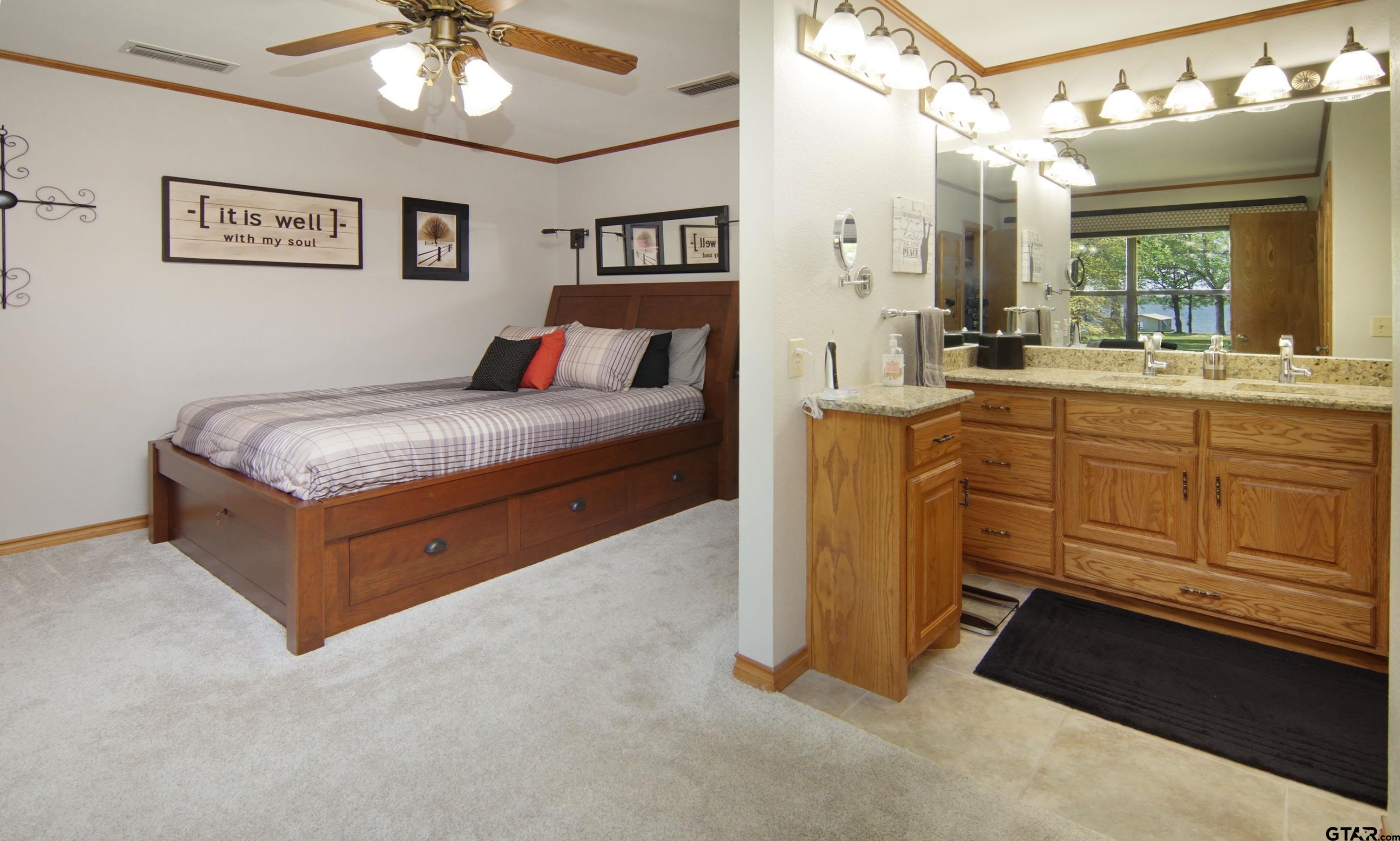 227 Private Road 5885 Yantis, TX 75497 - Photo 40 of 41 a spacious bedroom with a bed and a chandelier