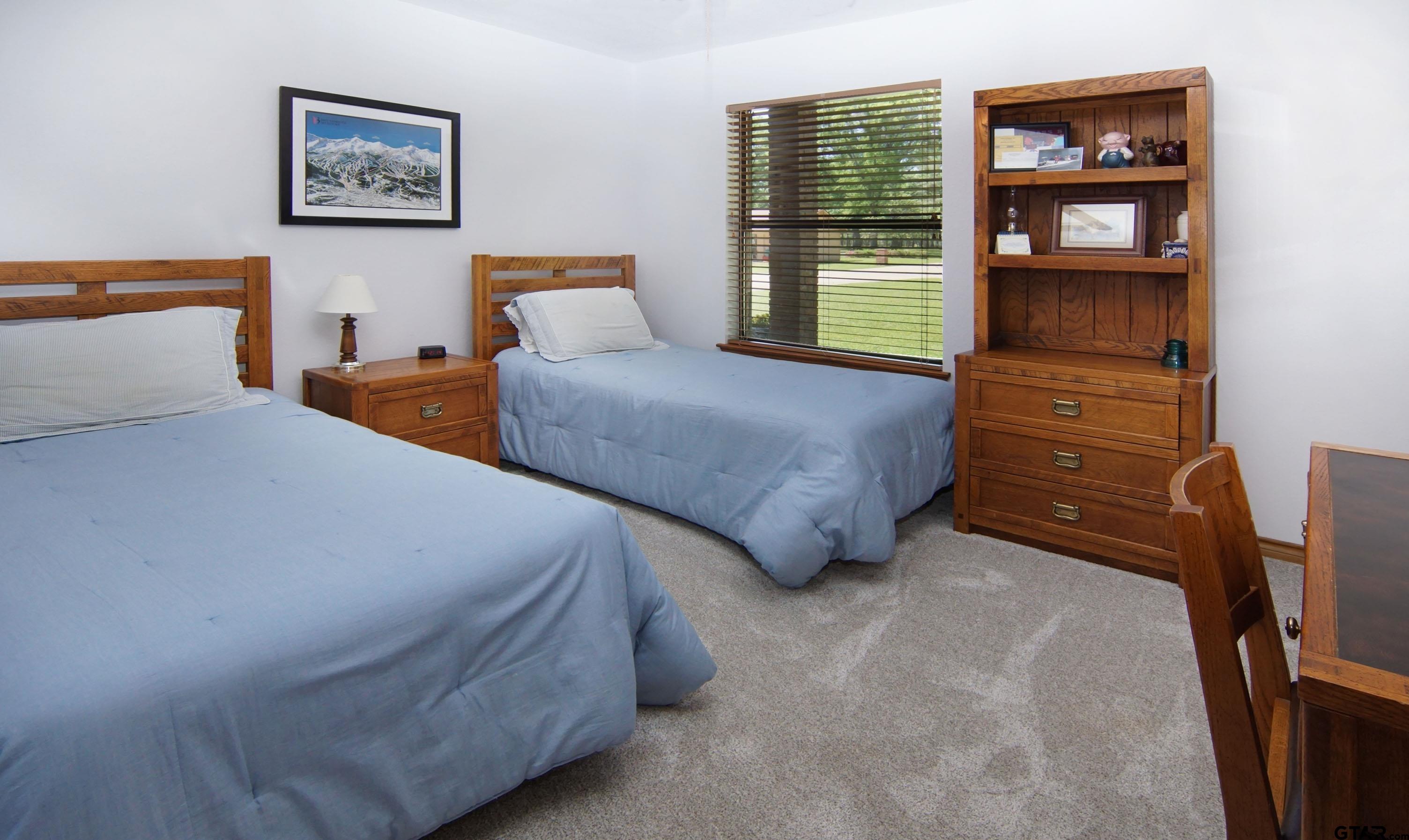 227 Private Road 5885 Yantis, TX 75497 - Photo 9 of 41 a bedroom with a bed and a dresser next to a window