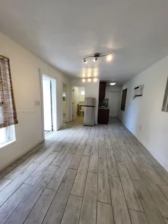 a view of a room with wooden floor
