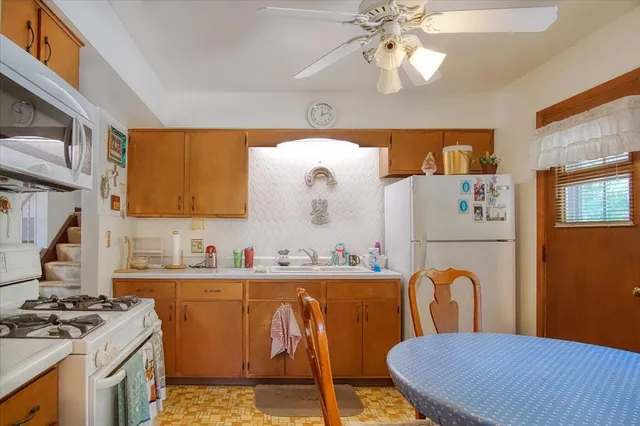 a view of a dining room with furniture and chandelier