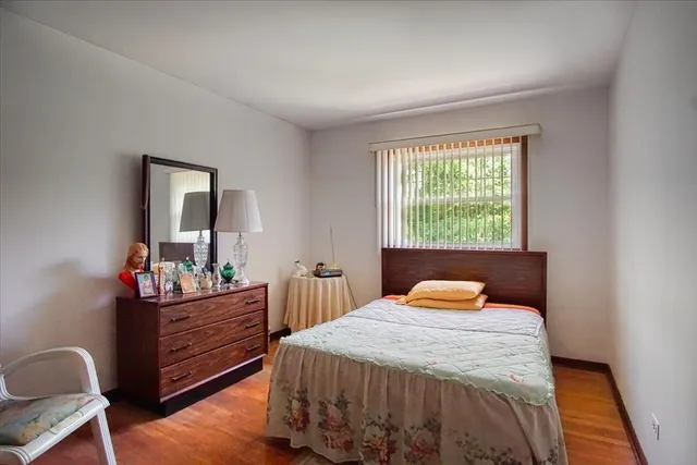 a bedroom with a bed and window