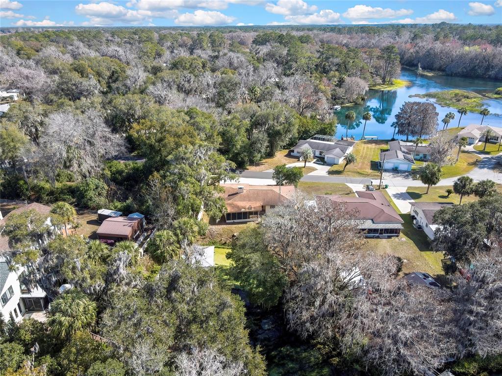 12130 Maple Street Dunnellon, FL 34432 - Photo 14 of 54 a aerial view of a house with a yard and lake view