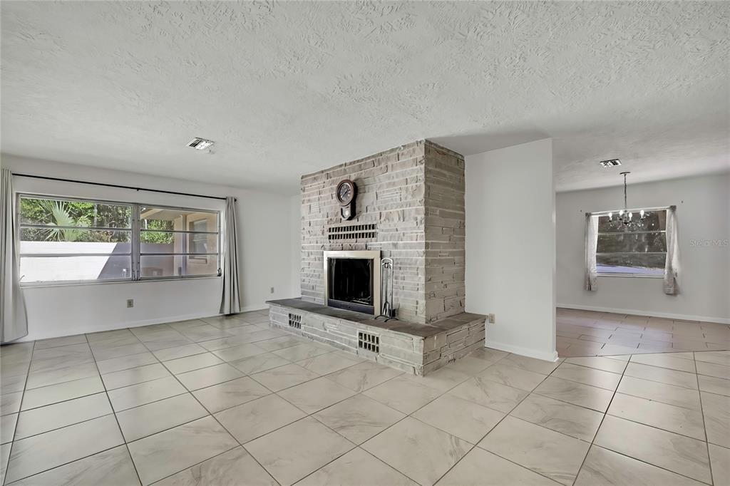 12130 Maple Street Dunnellon, FL 34432 - Photo 20 of 54 a view of an empty room with a fireplace and window
