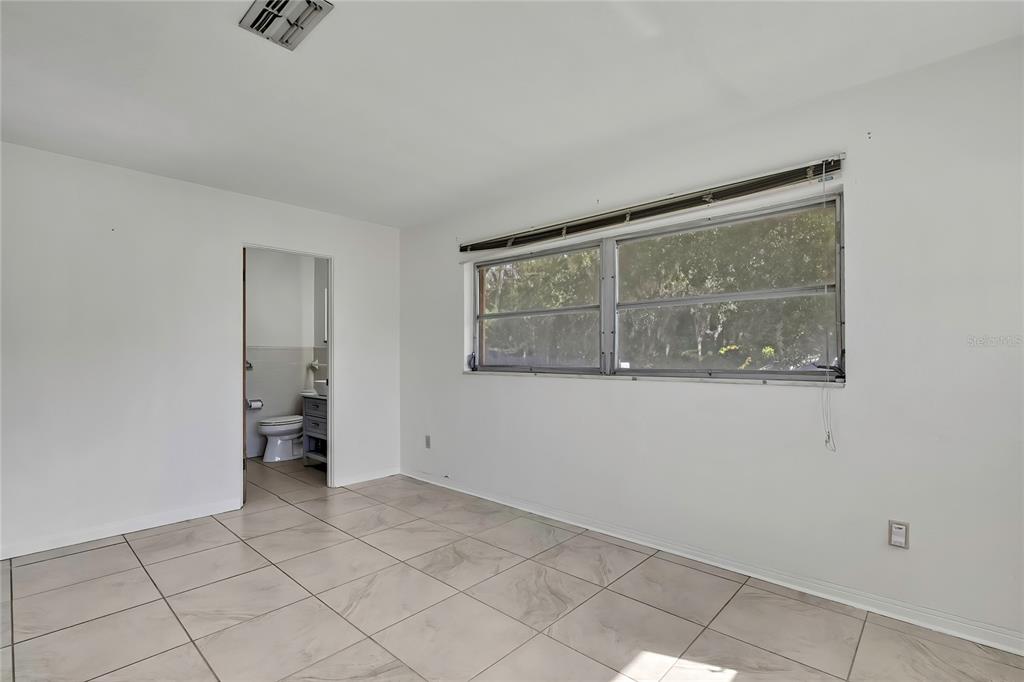 12130 Maple Street Dunnellon, FL 34432 - Photo 25 of 54 a view of an empty room with a window