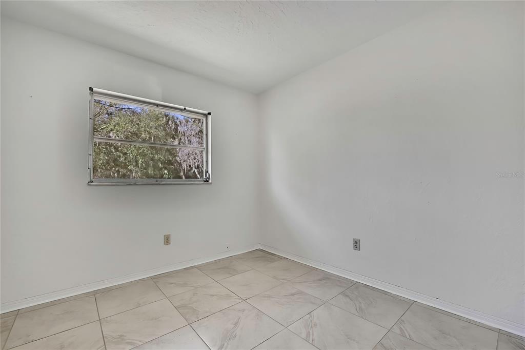 12130 Maple Street Dunnellon, FL 34432 - Photo 27 of 54 an empty room with a painting on the wall