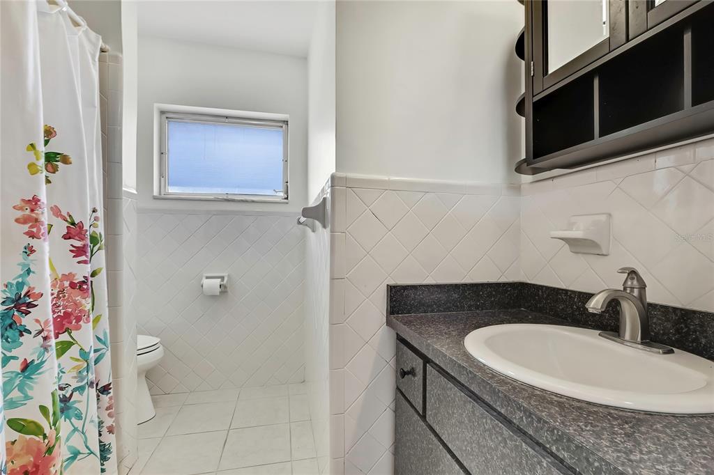 12130 Maple Street Dunnellon, FL 34432 - Photo 30 of 54 a bathroom with a granite countertop sink a toilet and shower