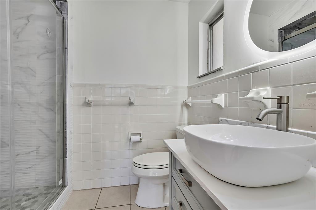 12130 Maple Street Dunnellon, FL 34432 - Photo 36 of 54 a white toilet sitting next to a bathroom sink