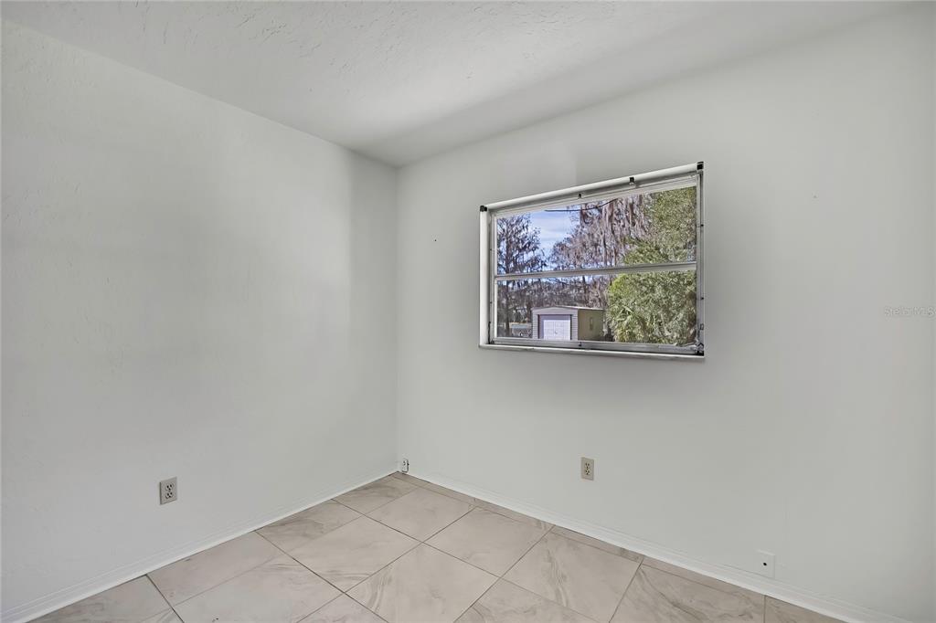 12130 Maple Street Dunnellon, FL 34432 - Photo 37 of 54 an empty room with a window