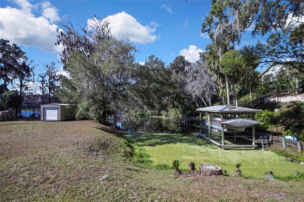12130 Maple Street Dunnellon, FL 34432 - Photo 42 of 54 a front view of house with yard and trees in the background