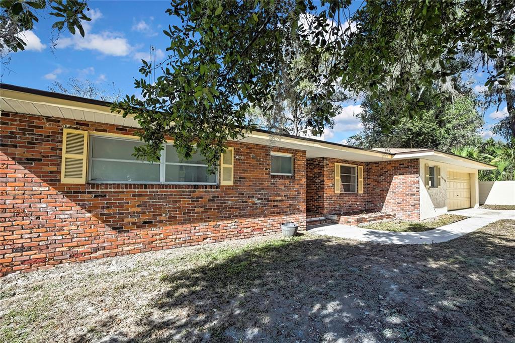 12130 Maple Street Dunnellon, FL 34432 - Photo 44 of 54 a view of a house with backyard and sitting area