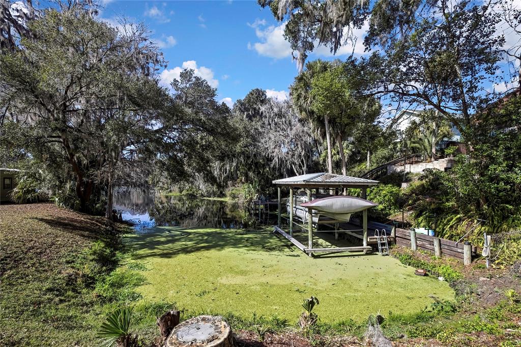 12130 Maple Street Dunnellon, FL 34432 - Photo 47 of 54 a backyard of a house with table and chairs