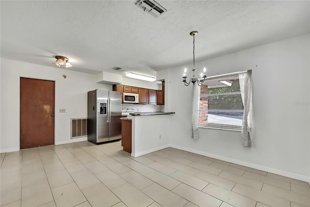 12130 Maple Street Dunnellon, FL 34432 - Photo 6 of 54 a kitchen with stainless steel appliances granite countertop a refrigerator and microwave