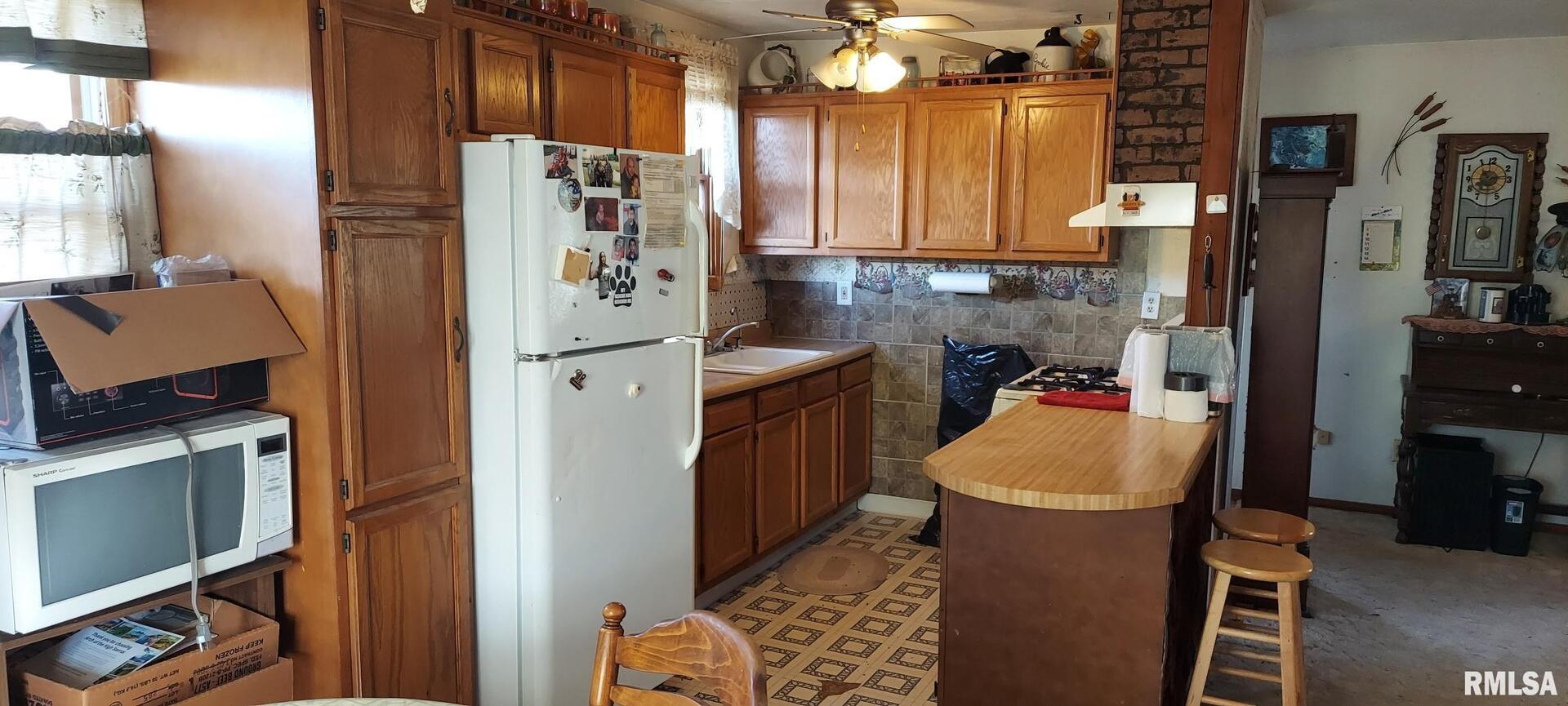 862 270th Street Viola, IL 61486 - Photo 11 of 17 a kitchen with stainless steel appliances a refrigerator and a stove top oven