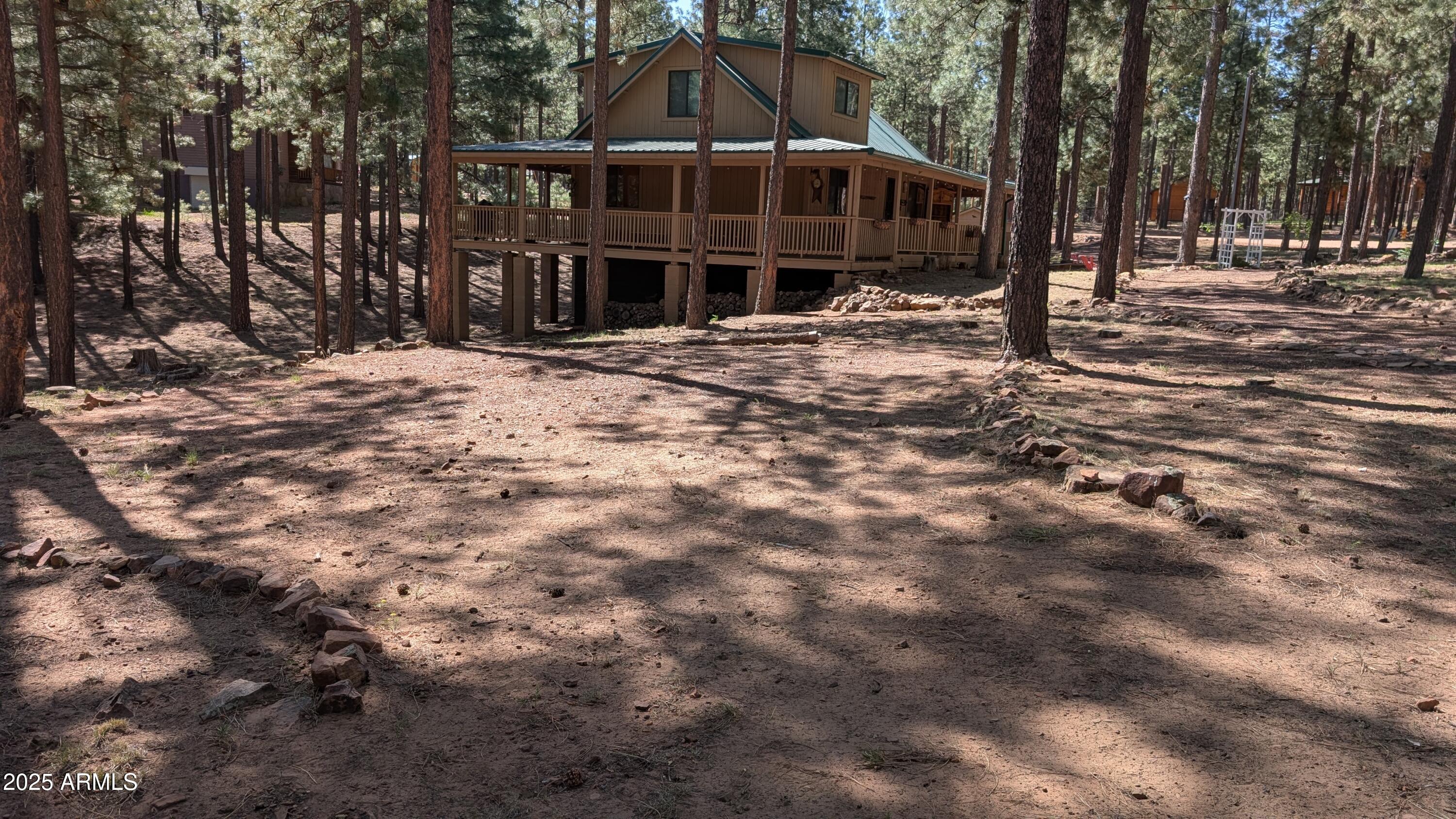 2425 Tall Trees Loop Forest Lakes, AZ 85931 - Photo 7 of 43 a front view of a house with a yard covered with snow