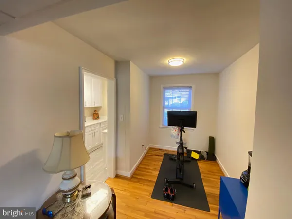 a living room with furniture and a lamp