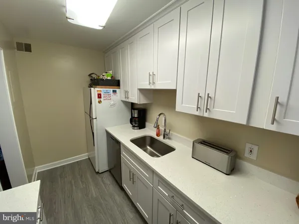 a kitchen with stainless steel appliances a sink stove and cabinets