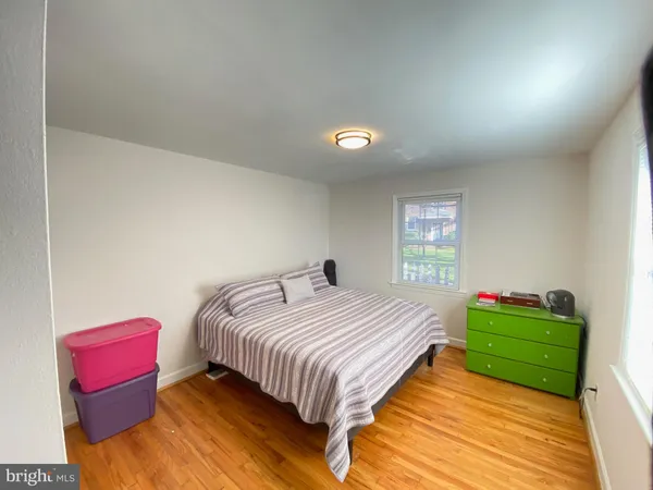 a bedroom with beds and a chair