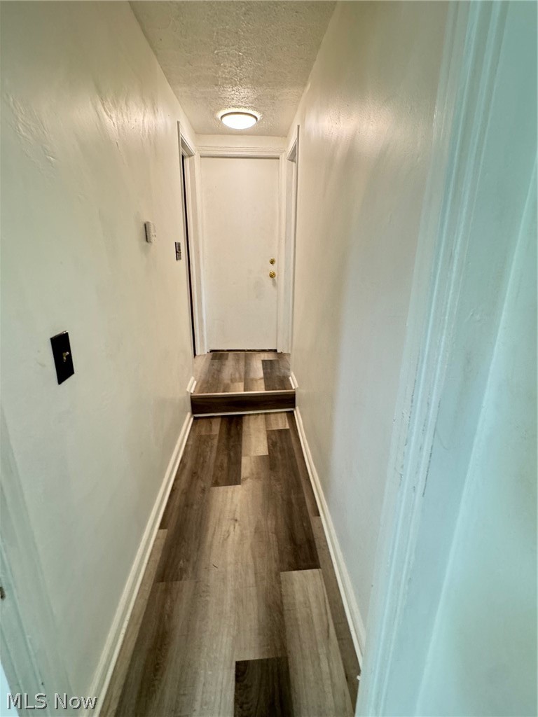 459 Patterson Avenue Akron, OH 44310 - Photo 20 of 24 1st floor Hall with hardwood / wood-style flooring and a textured ceiling leading to bedrm and bathroom