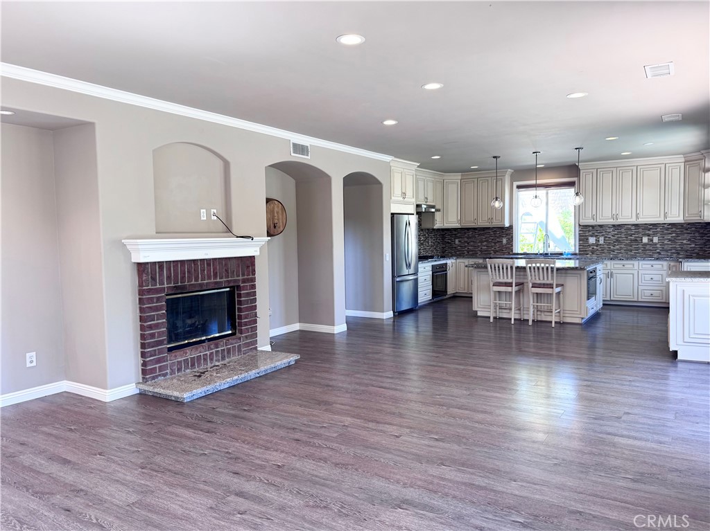 28463 Cascade Road Castaic, CA 91384 - Photo 9 of 29 a living room with furniture a fireplace and a wooden floor