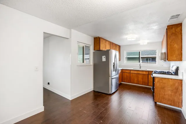 a kitchen with stainless steel appliances a stove a microwave and sink