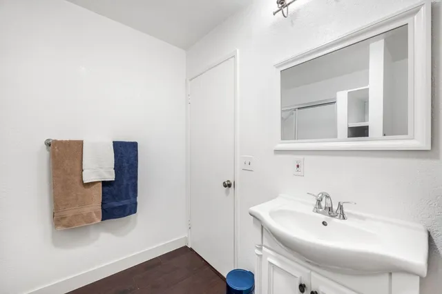 a bedroom with bed and wooden floor