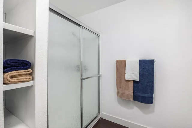 a bedroom with a bed and a painting on the wall