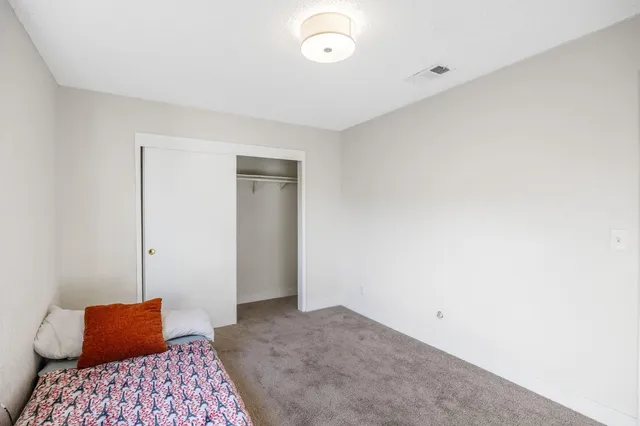 a view of a house with wooden fence