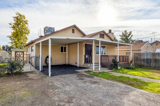 a view of a house with yard and a garden