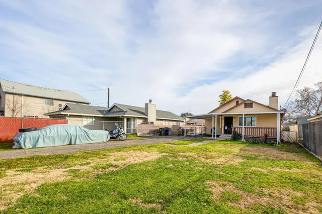a front view of house with yard outdoor seating and barbeque oven