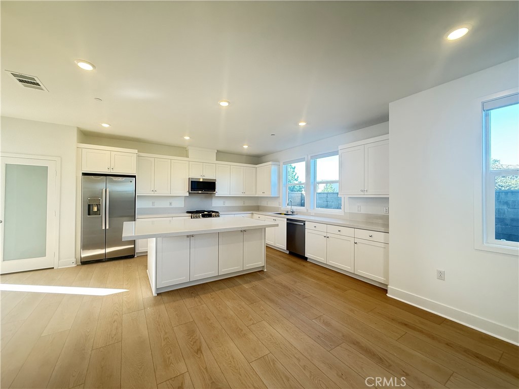 313 Proctor Irvine, CA 92618 - Photo 3 of 24 a large kitchen with a center island and stainless steel appliances