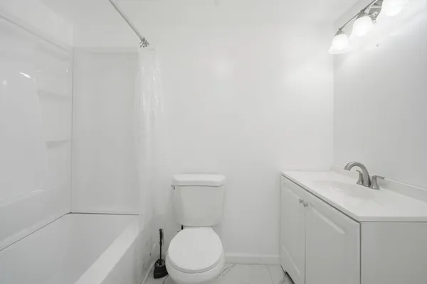 a bathroom with a sink a toilet and bathtub