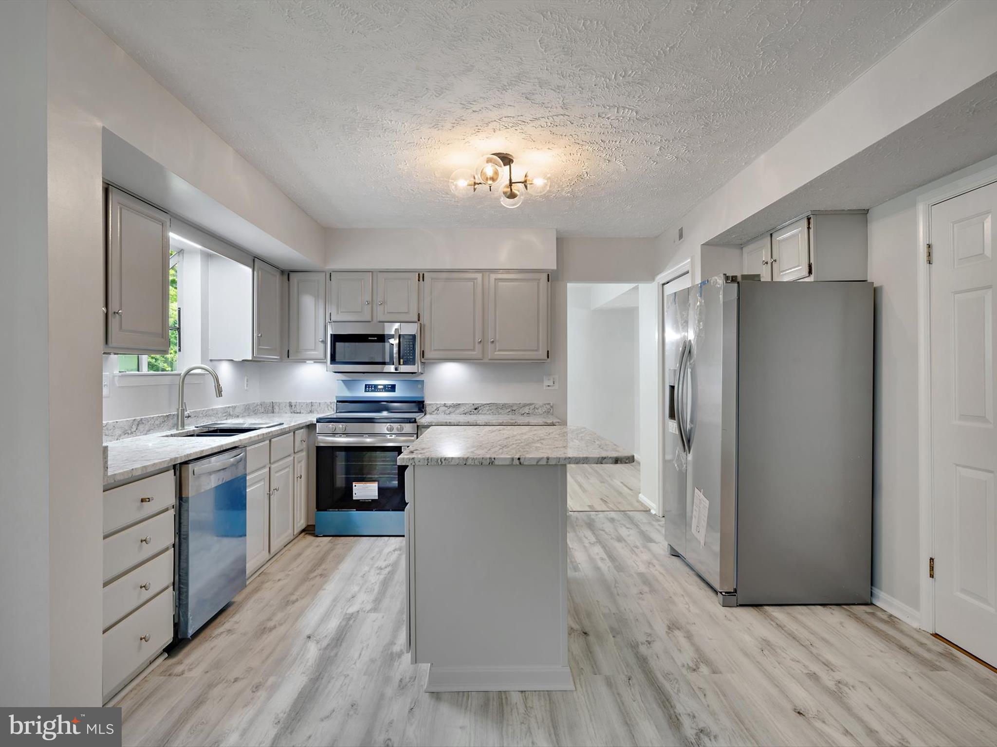 3228 Blackwalnut Drive Annapolis, MD 21403 - Photo 12 of 55 a kitchen with a refrigerator a stove top oven a sink and dishwasher