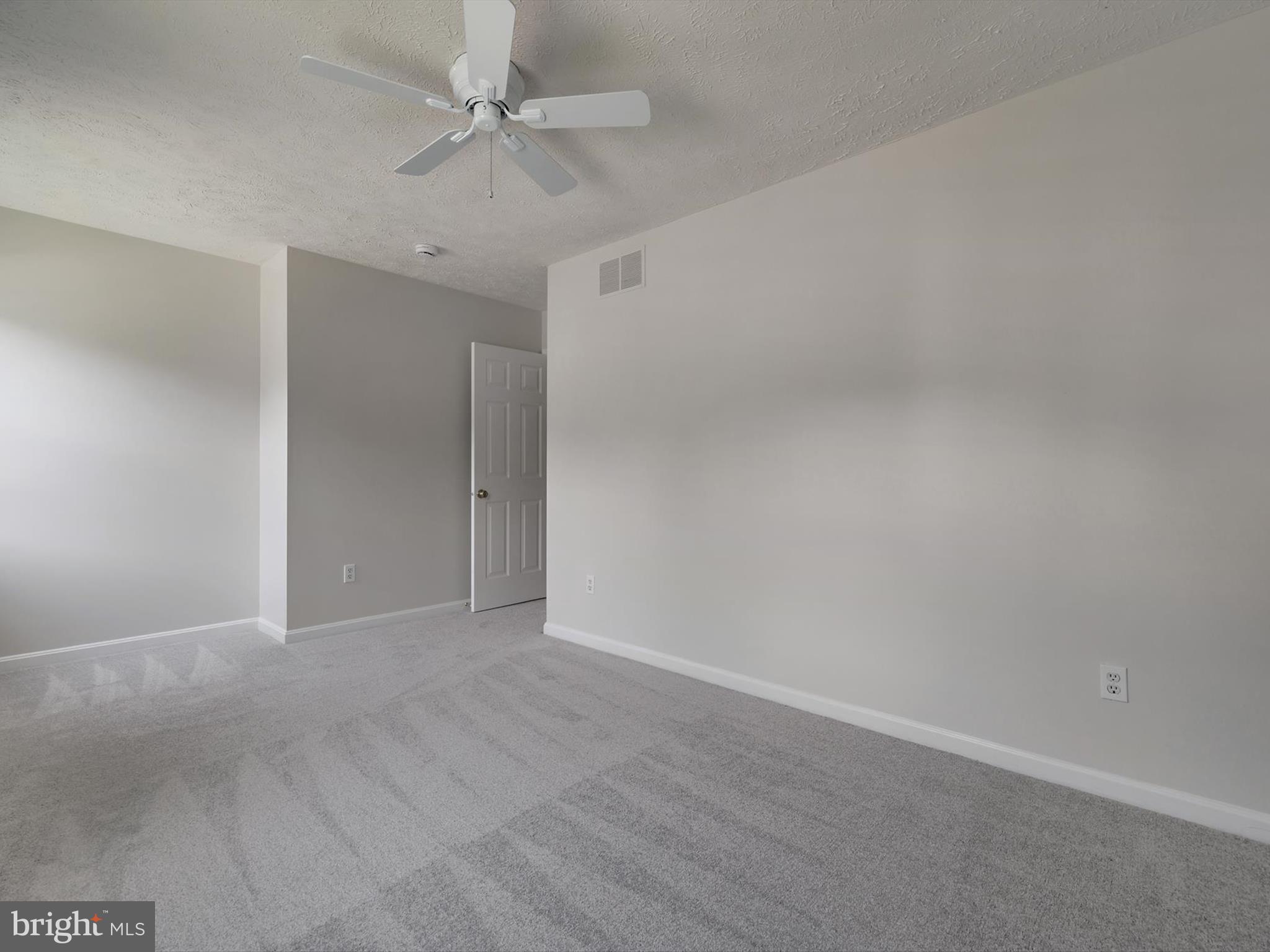 3228 Blackwalnut Drive Annapolis, MD 21403 - Photo 27 of 55 an empty room with a ceiling fan and carpet
