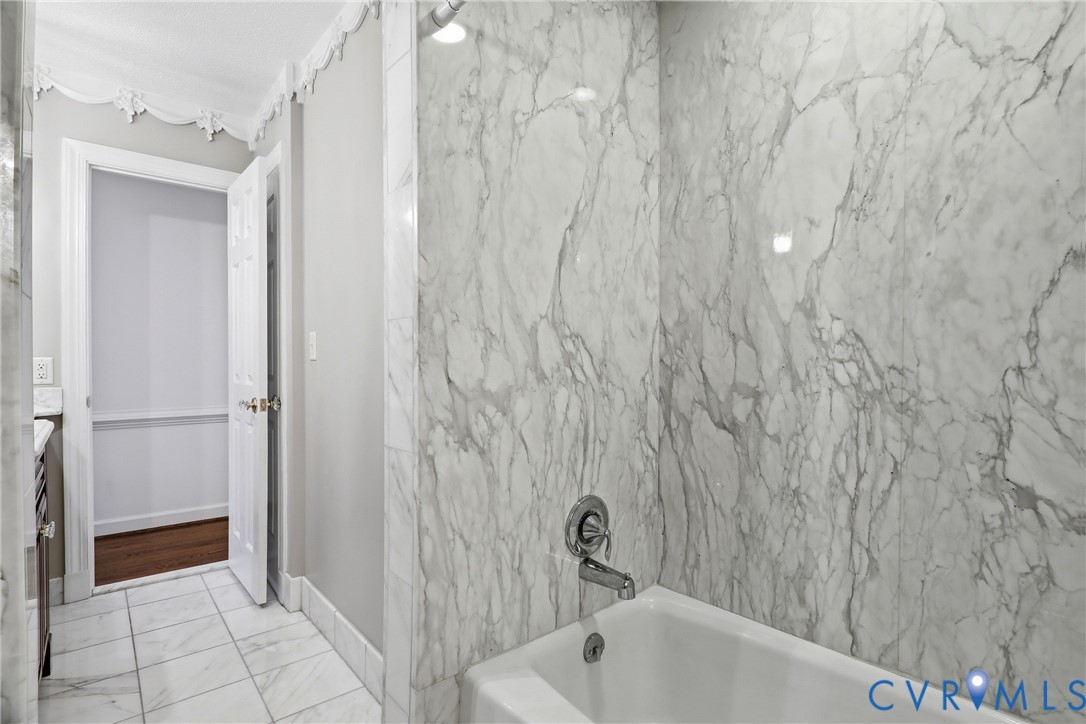 13300 West Patrick Henry Road Doswell, VA 23047 - Photo 22 of 69 Bathroom featuring a built-in tub with chrome fixt