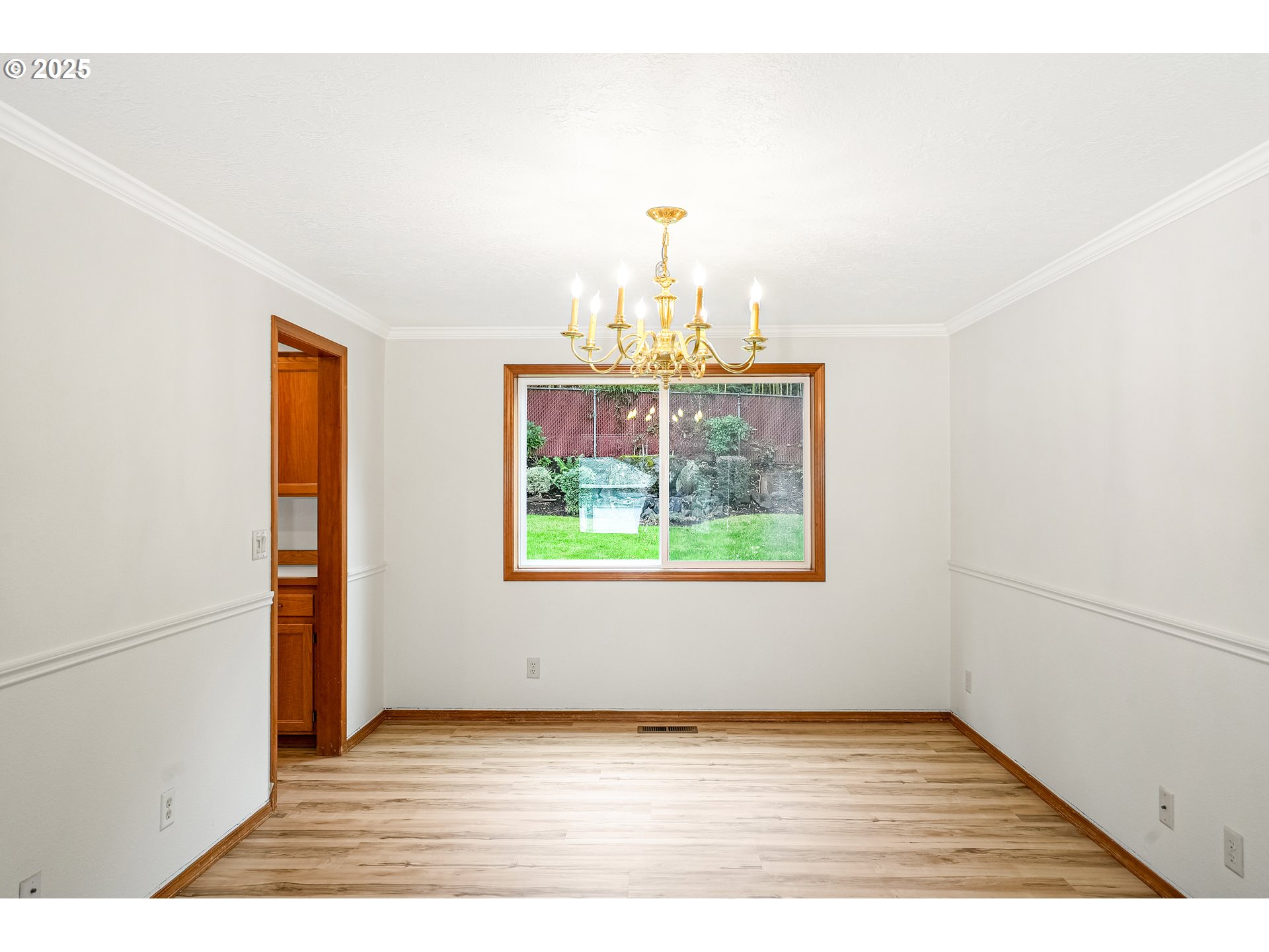 5561 Springwood Avenue Southeast Salem, OR 97306 - Photo 11 of 42 a view of an empty room with wooden floor and a window