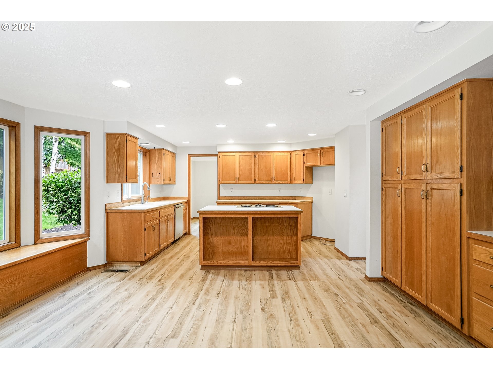5561 Springwood Avenue Southeast Salem, OR 97306 - Photo 13 of 42 a kitchen with a refrigerator and wooden cabinets